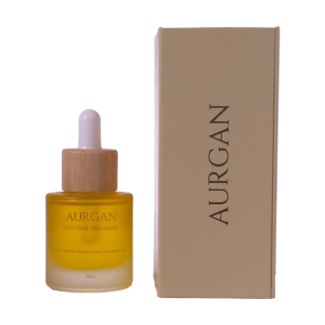 Aurgan Silky Hair Treatment fles naast de zijkant van de verpakking